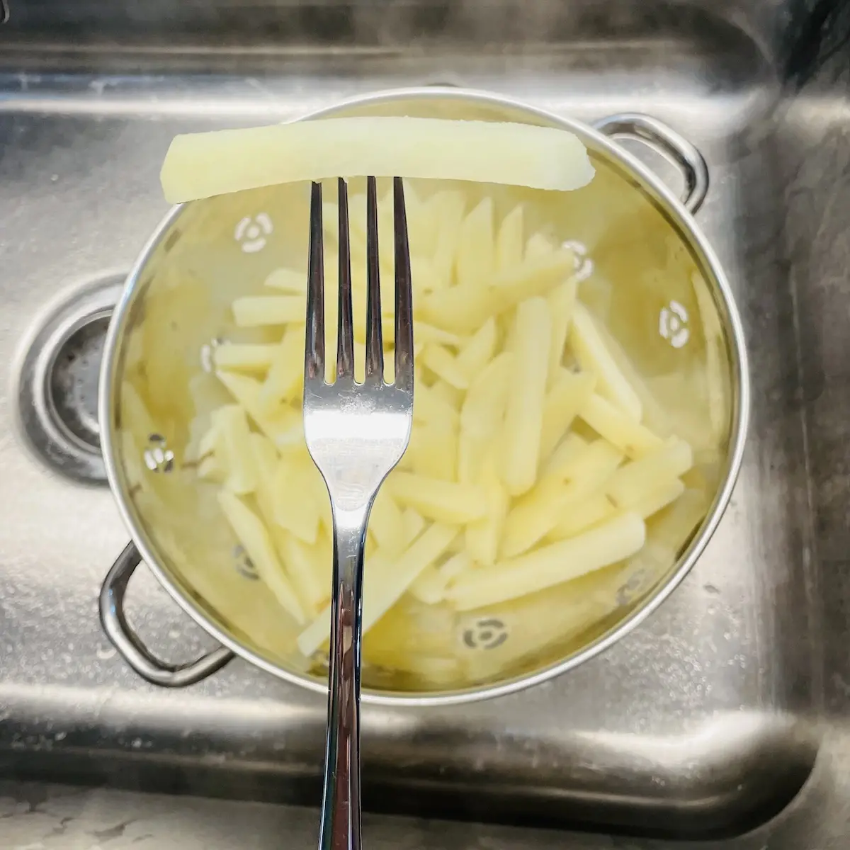 Oven French Fries Step 2 Drain Boiled Potatoes in Sink