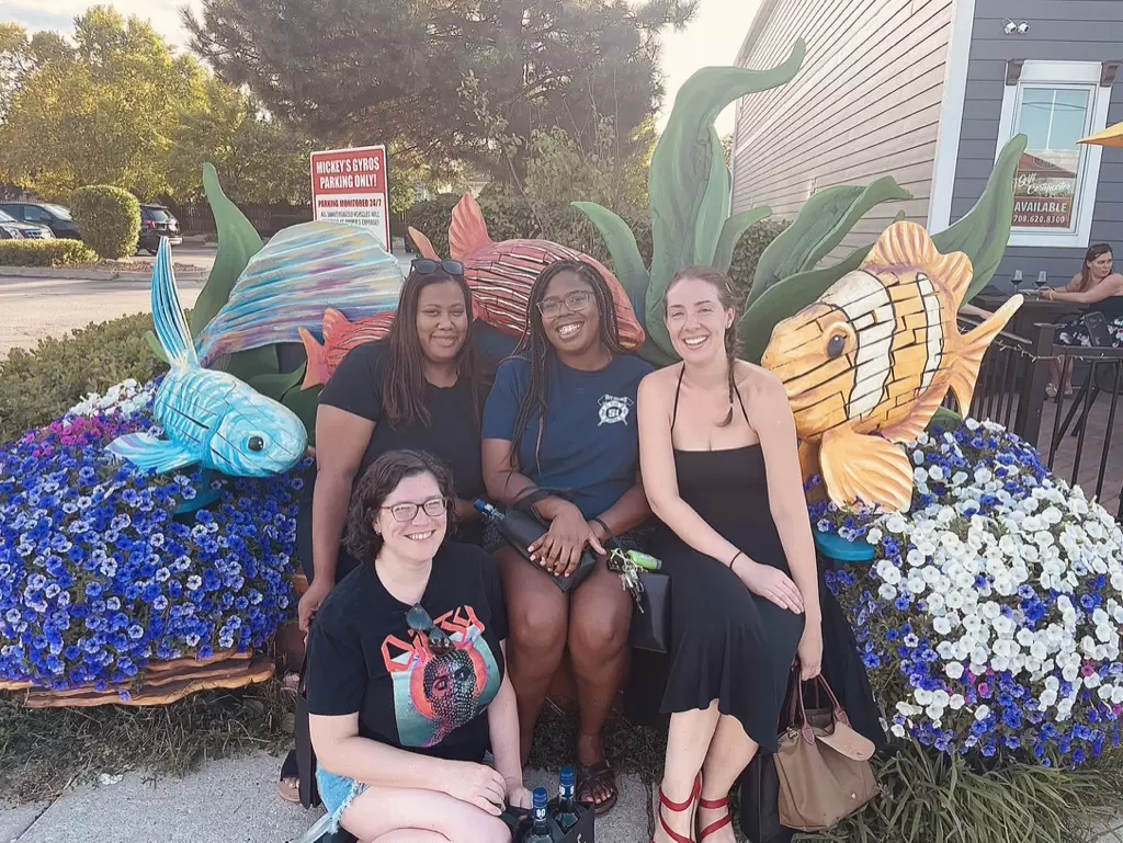 Tinley Park Moms - Sarah, Kehla, Ashley, and Stephanie Pyrzynski in front of sip wine bar on Oak Park Avenue, on one of the Benches on the Avenue in Tinley Park
